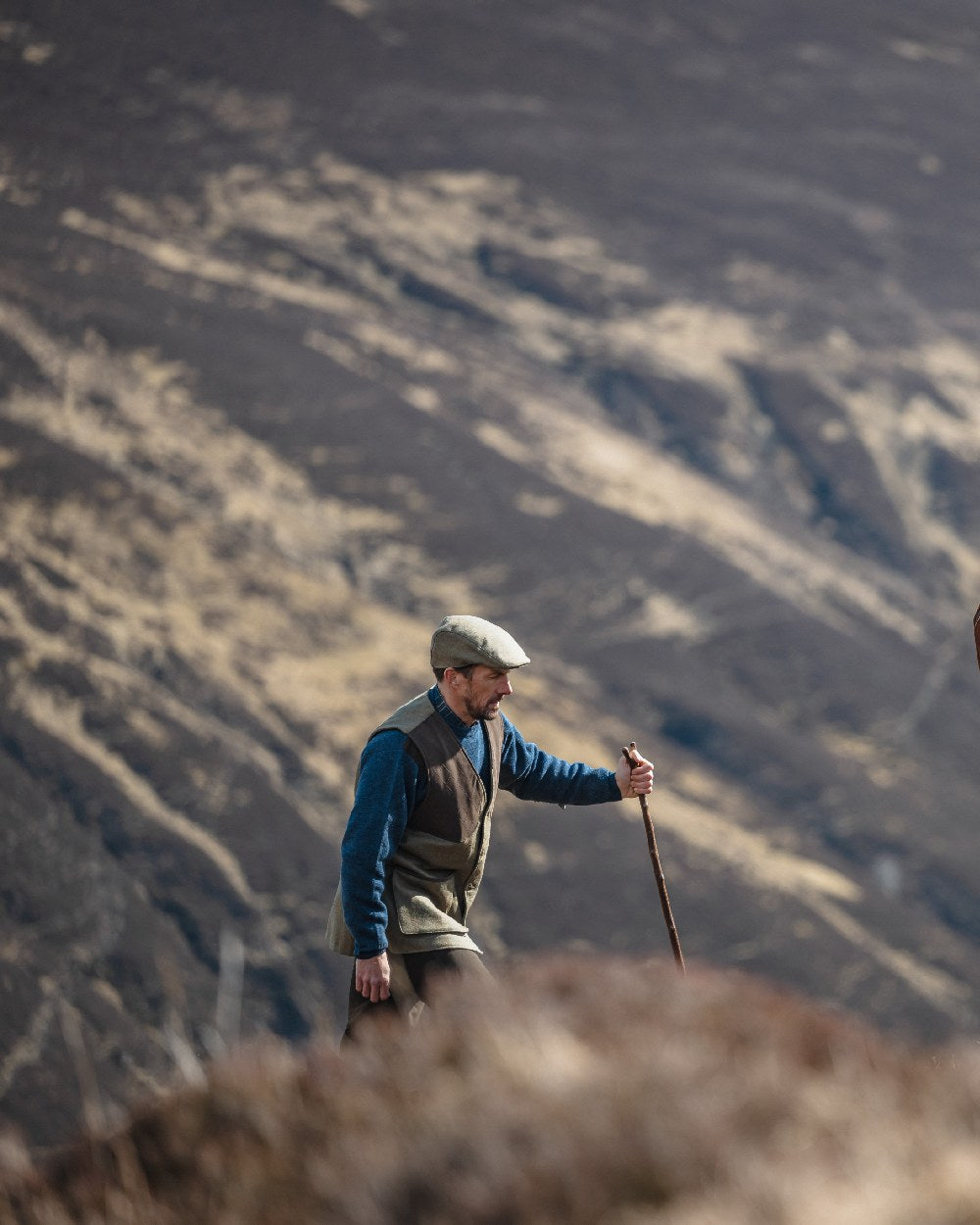 Autumn Bracken Coloured Hoggs of Fife Kinloch Technical Tweed Field Waistcoat on mountain background #colour_autumn-bracken