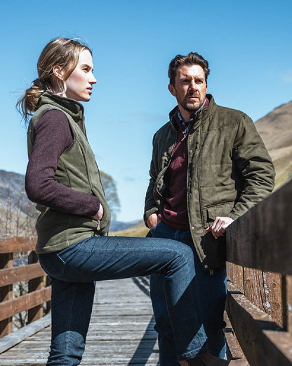 Loden coloured Hoggs of Fife Mens Glenesk Quilted Jacket on mountain background #colour_loden