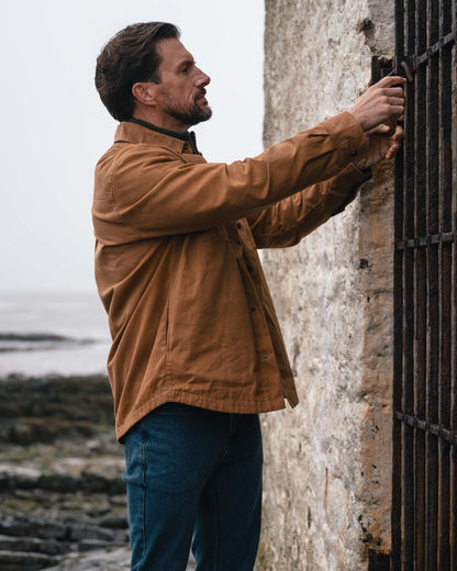 Caramel coloured Hoggs of Fife Mens Huntly Waxed Canvas Utility Overshirt on coastal background #colour_caramel