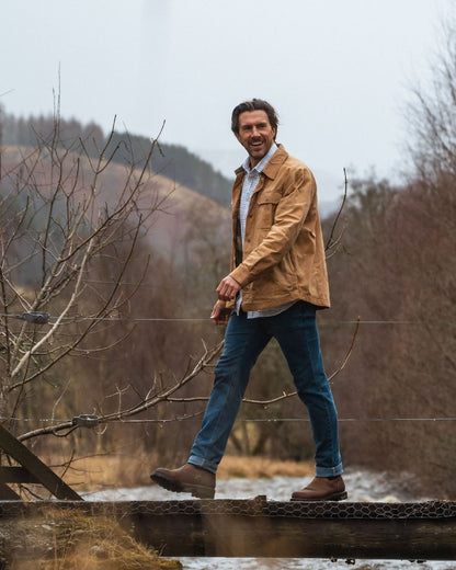 Tan Coloured Hoggs of Fife Mens Huntly Waxed Canvas Utility Overshirt on mountain background #colour_tan