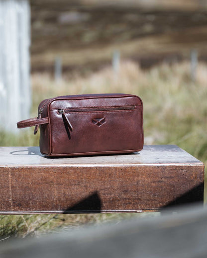 Conker Coloured Hoggs of Fife Monarch Leather Wash Bag on outdoor background #colour_conker