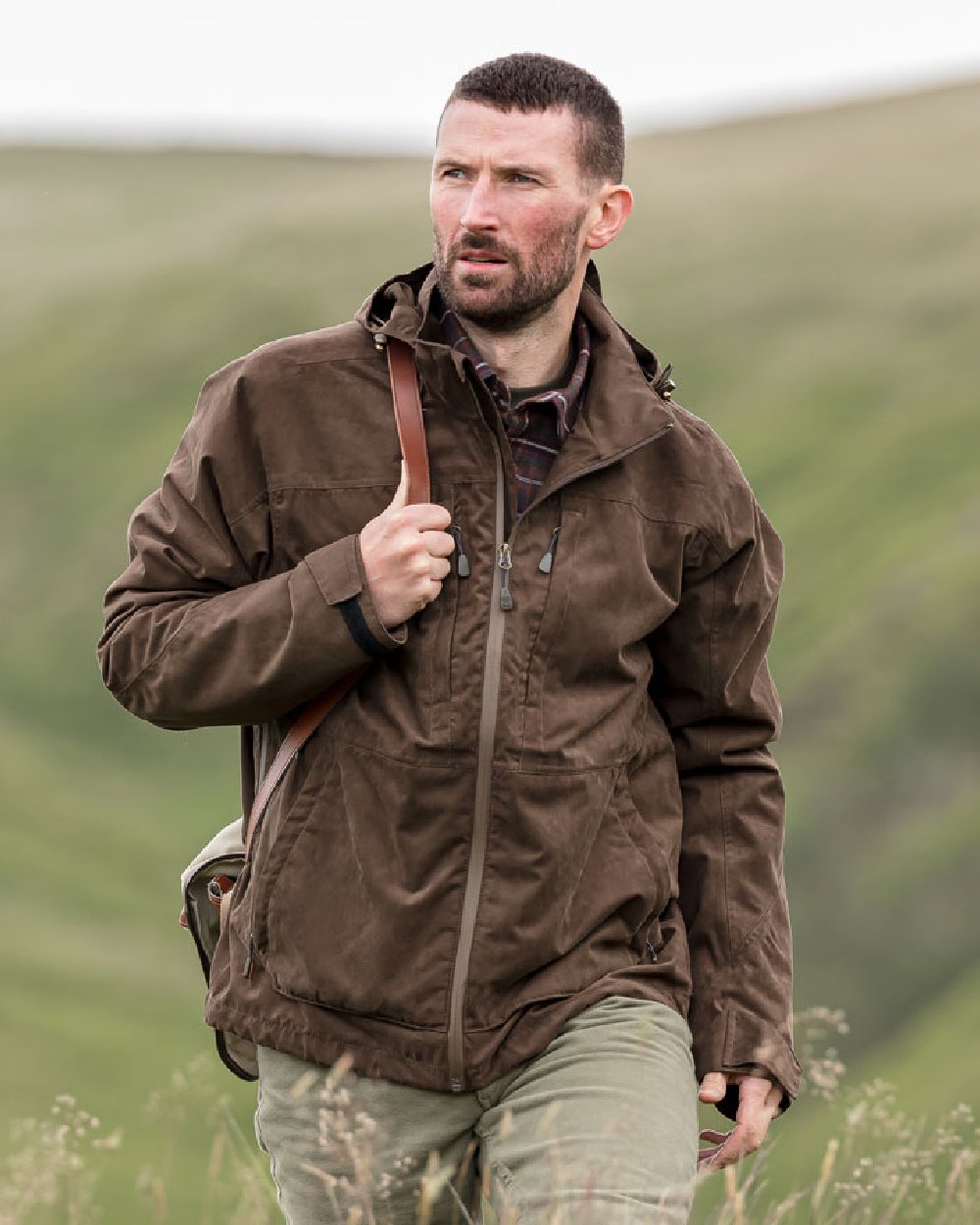 Brown Coloured Hoggs of Fife Rannoch Waterproof Shooting Jacket on blurry background #colour_brown