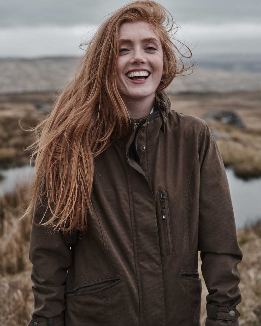 Sage Coloured Hoggs of Fife Struther Ladies Long Riding Coat on pond background #colour_sage