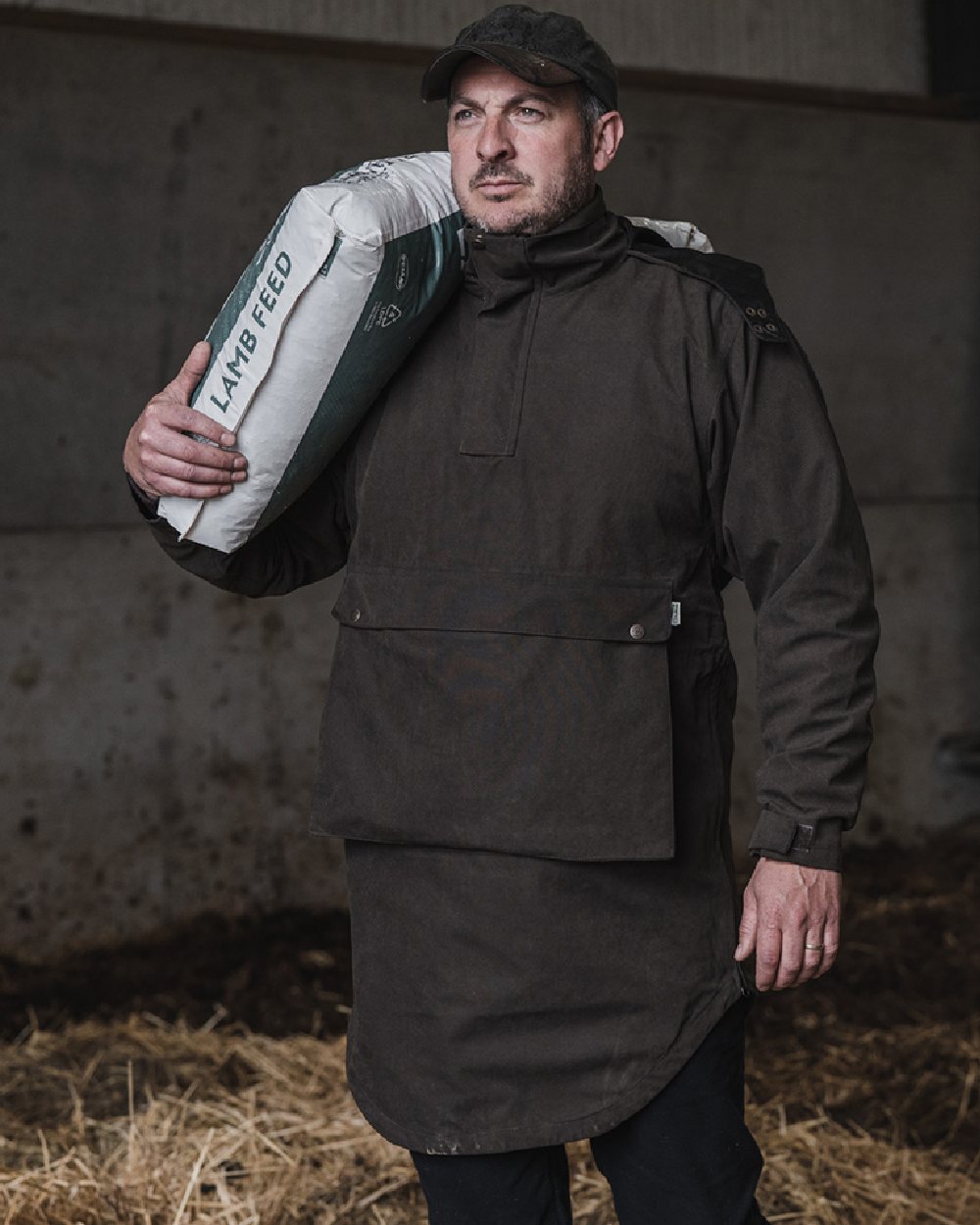 Dark Green coloured Hoggs of Fife Struther Trilaminate Long Waterproof Smock on grass background #colour_dark-green