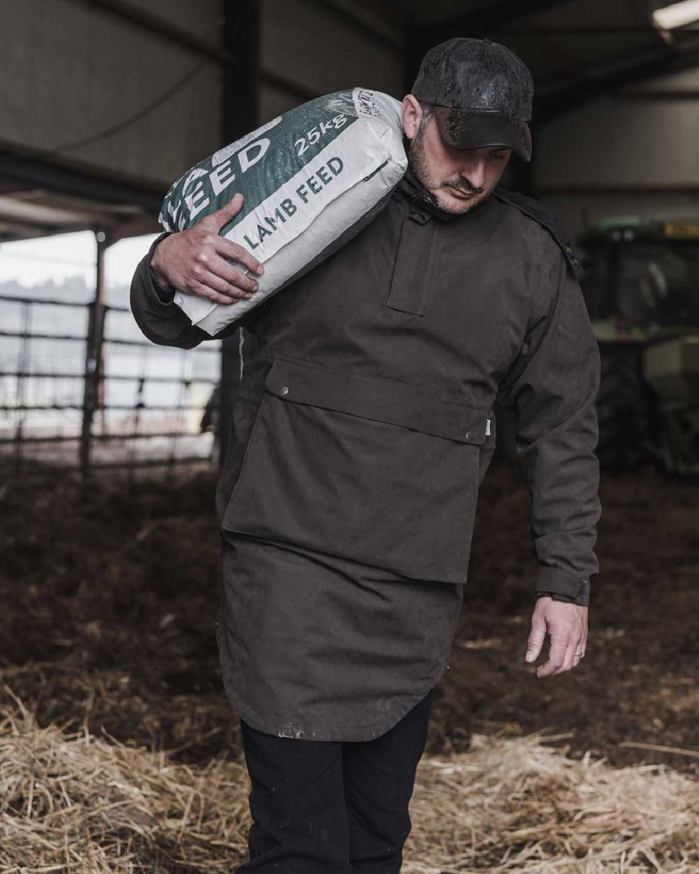 Dark Green coloured Hoggs of Fife Struther Trilaminate Long Waterproof Smock on grass background #colour_dark-green
