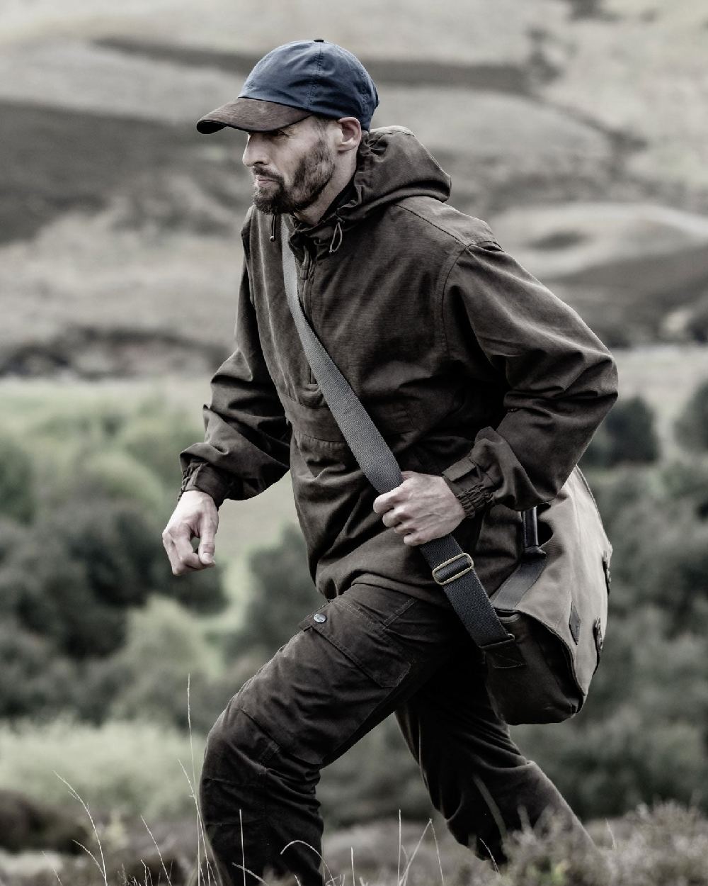 Dark Green coloured Hoggs of Fife Struther Waterproof Field Trousers on forest background #colour_dark-green