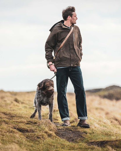 Dark Green coloured Hoggs of Fife Struther Waterproof Lightweight Jacket on mountain background #colour_dark-green