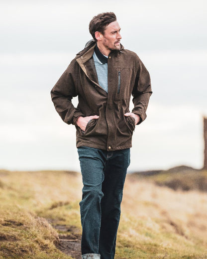 Dark Green coloured Hoggs of Fife Struther Waterproof Lightweight Jacket on mountain background #colour_dark-green