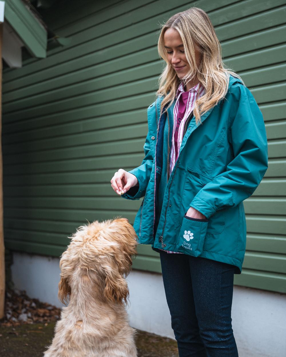 Teal Coloured Hoggs of Fife Womens Fara Waterproof Jacket on countryside background #colour_teal