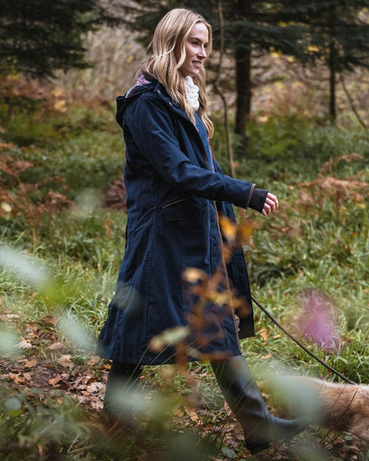 Navy coloured Hoggs of Fife Womens Walker Long Coat on forest background #colour_navy