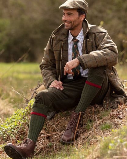 Spruce Brick Red coloured House of Cheviot Estate Field Socks on field background #colour_spruce-brick-red