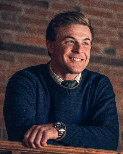 Navy coloured Jack Pyke Ashcombe Lambswool Crewknit Pullover on brick wall background #colour_navy