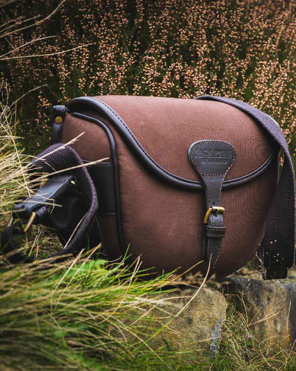 Brown coloured Jack Pyke Canvas Cartridge Bag on grassy background #colour_brown