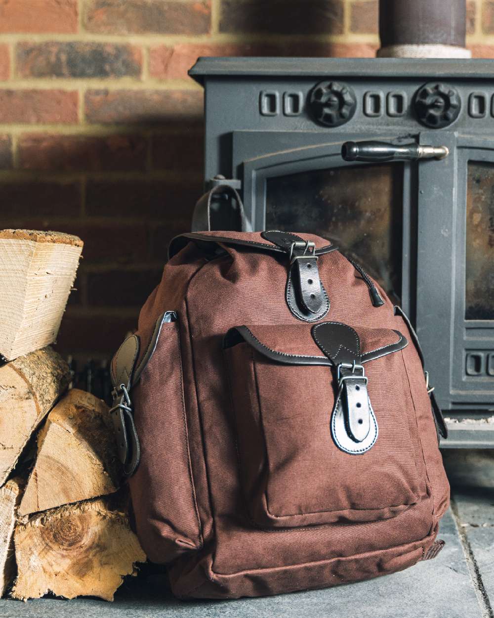 Brown coloured Jack Pyke Canvas Day Pack on wall background #colour_brown