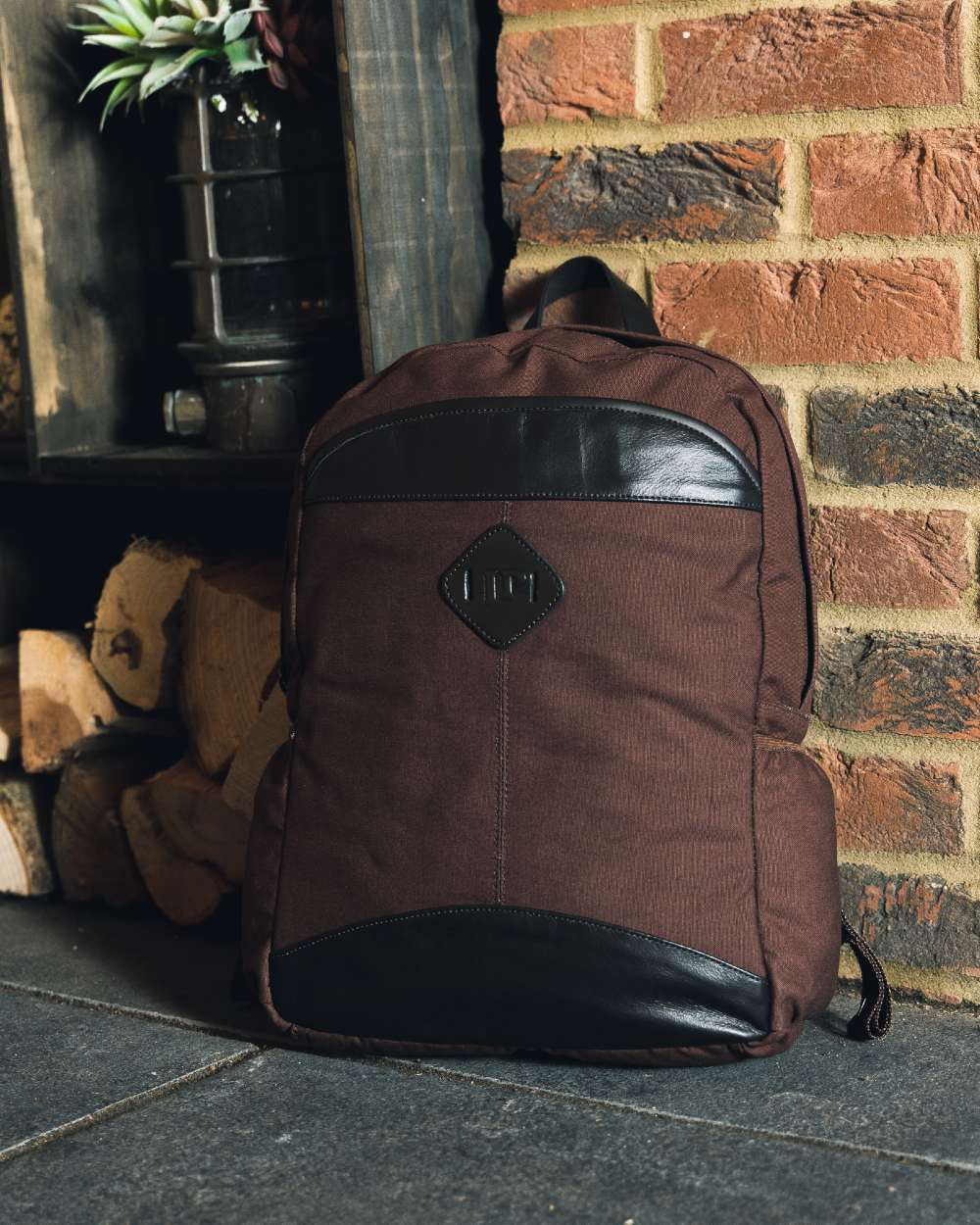 Brown coloured Jack Pyke Canvas Field Pack on brick wall background #colour_brown