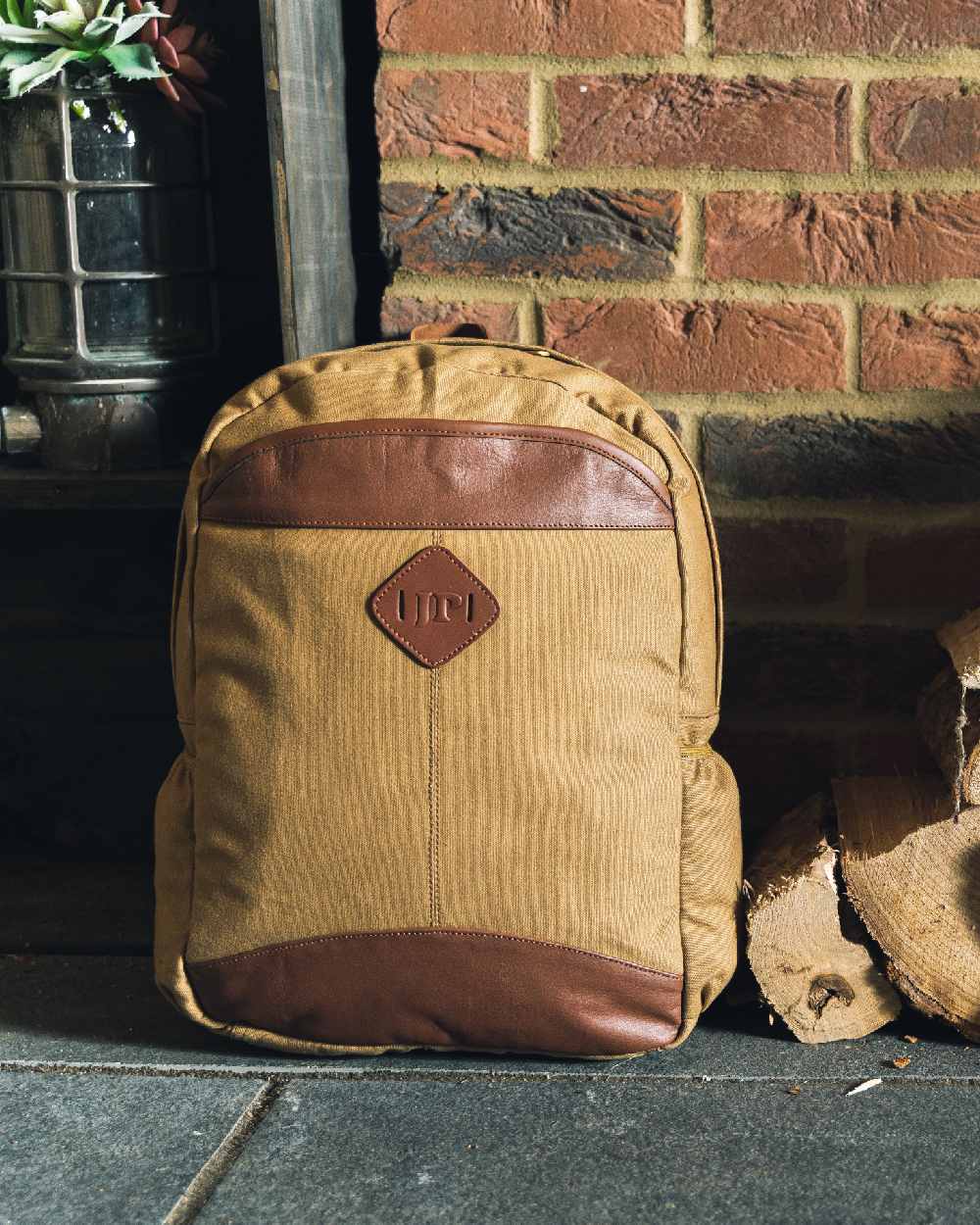 Fawn coloured Jack Pyke Canvas Field Pack on brick wall background #colour_fawn