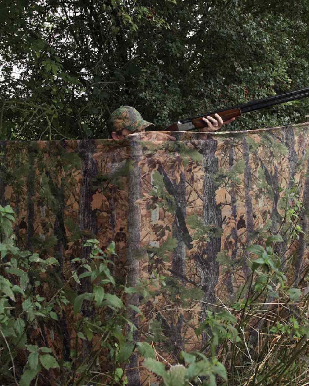 EVO coloured Jack Pyke Clearview Hide Net on forest background #colour_evo