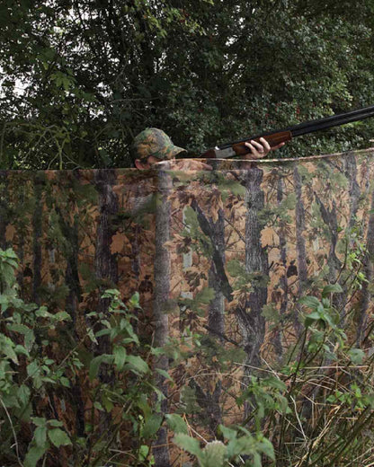 EVO coloured Jack Pyke Clearview Hide Net on forest background #colour_evo