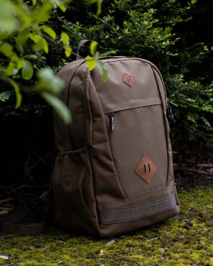 Olive Brown coloured Jack Pyke Falcon Rucksack on leafy background #colour_olive-brown