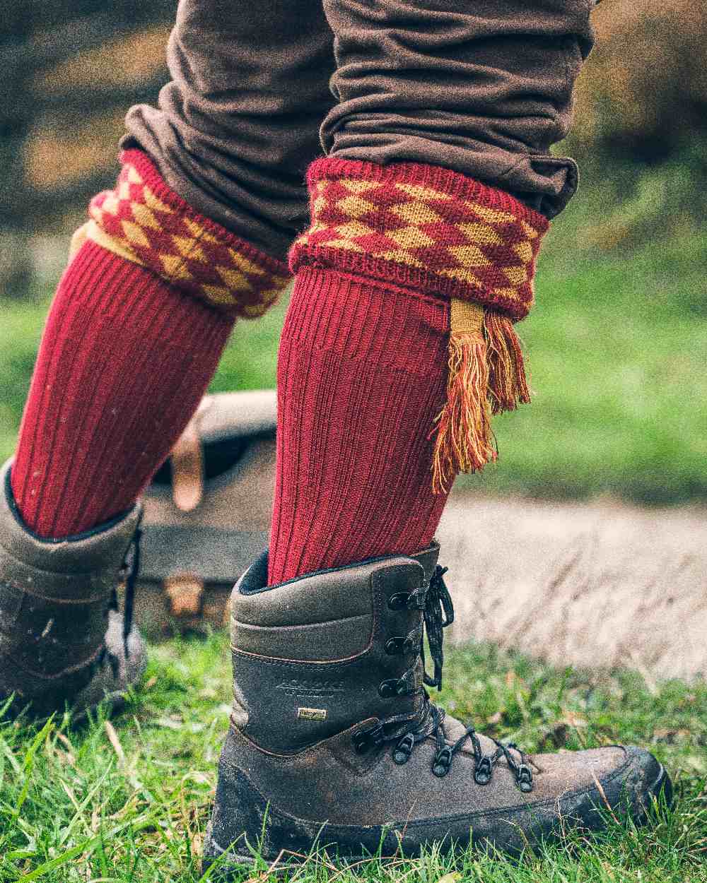 Burgundy Coloured Jack Pyke Harlequin Socks on outdoor background #colour_burgundy