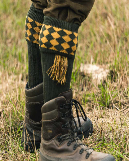 Green Coloured Jack Pyke Harlequin Socks on outdoor background #colour_green