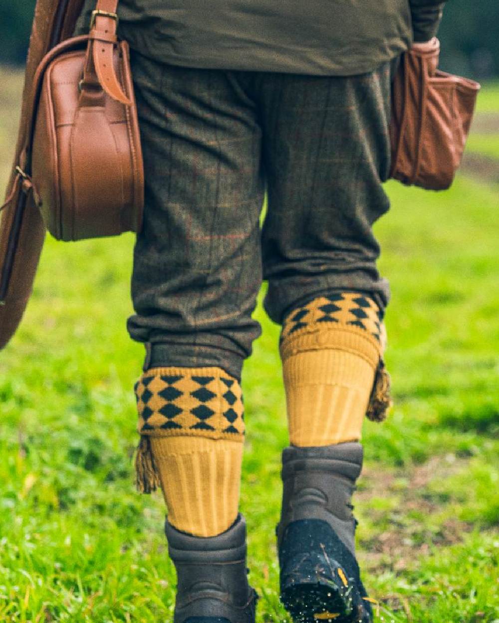 Mustard coloured Jack Pyke Harlequin Socks on grass background #colour_mustard