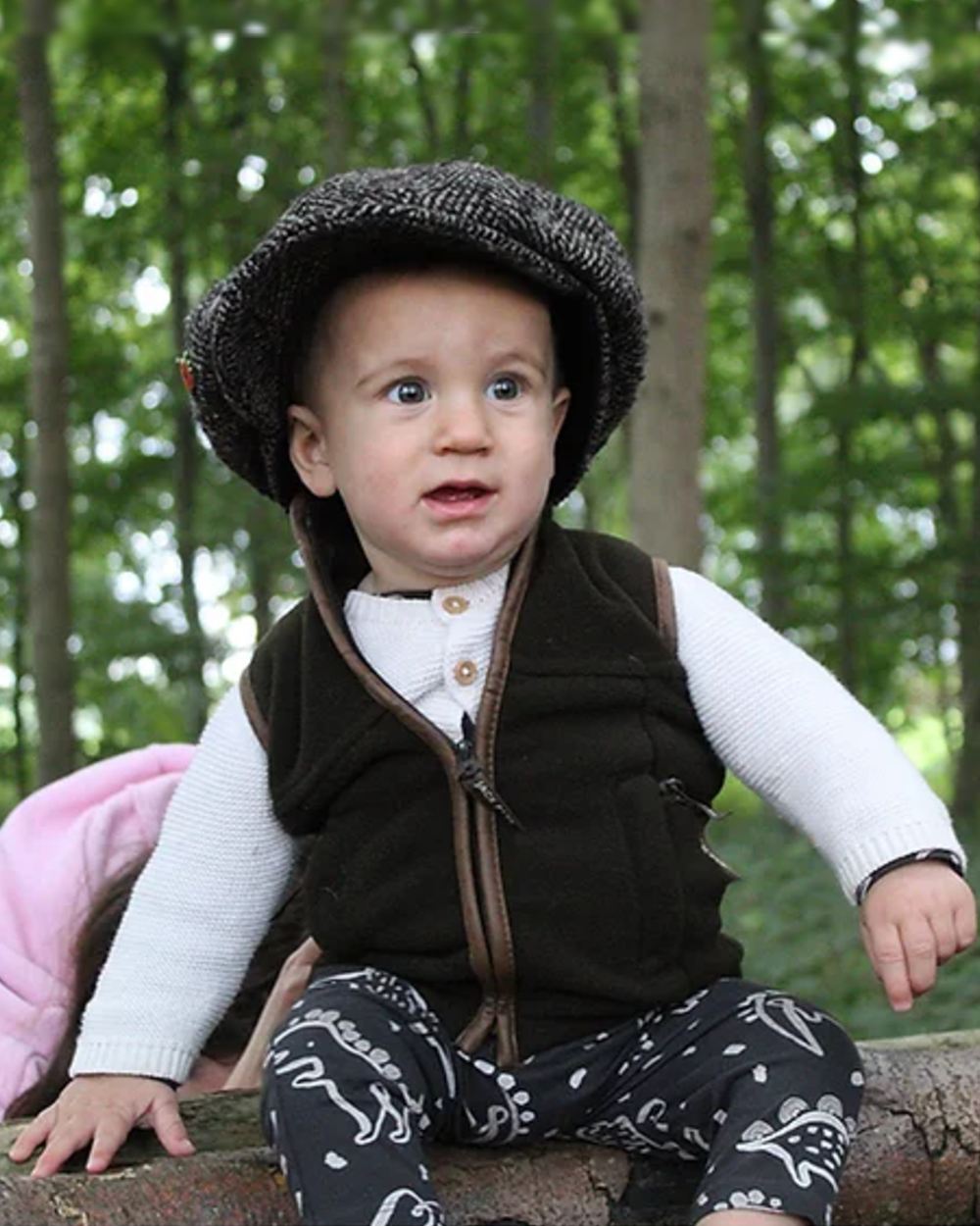 Dark Olive coloured Jack Pyke Junior Countryman Gilet on forest background #colour_dark-olive
