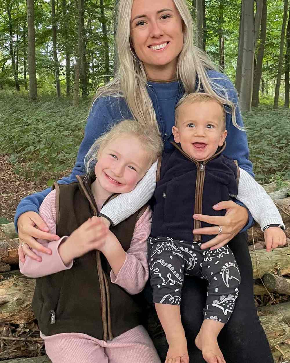 Dark Olive coloured Jack Pyke Junior Countryman Gilet on forest background #colour_dark-olive