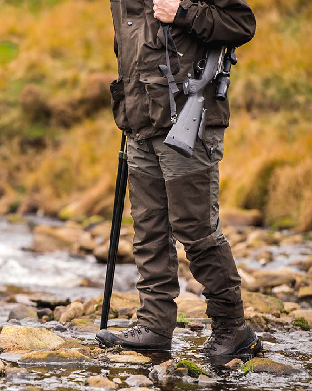 Green coloured Jack Pyke Mens Ashcombe Trousers on rock background #colour_green