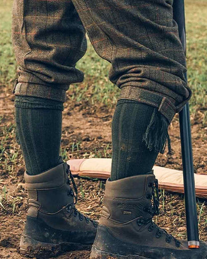 Green coloured Jack Pyke Plain Shooting Socks on mud background #colour_green