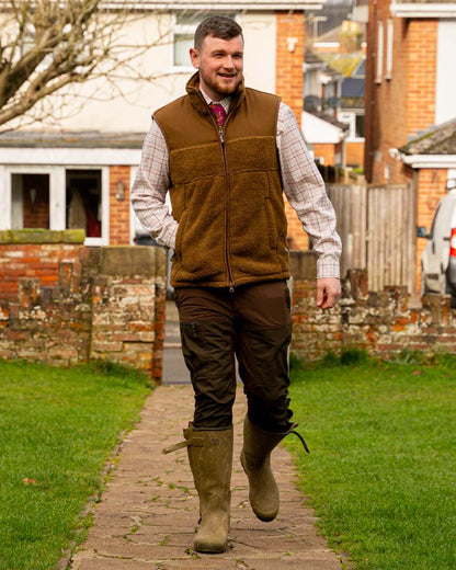 Camel coloured Jack Pyke Sherpa Fleece Gilet on house background #colour_camel