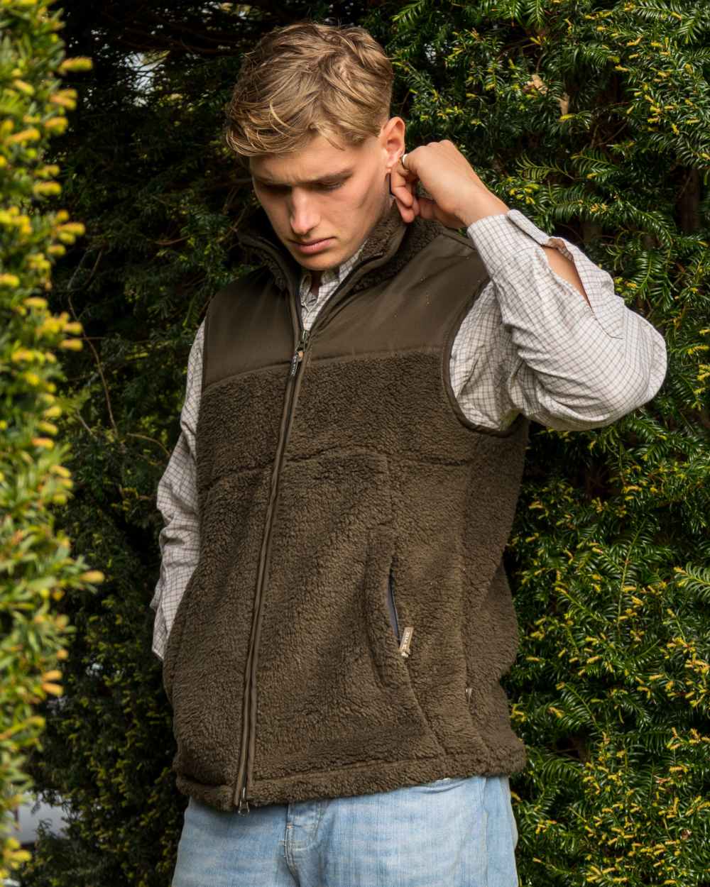 Dark Olive coloured Jack Pyke Sherpa Fleece Gilet on forest background #colour_dark-olive