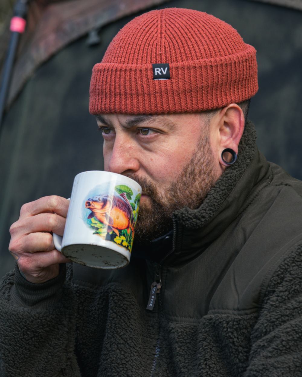 Dark Olive coloured Jack Pyke Sherpa Fleece Jacket Gen 2 on forest background #colour_dark-olive