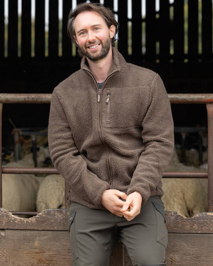 Green coloured Jack Pyke Shires Fleece Jacket on yard background #colour_green