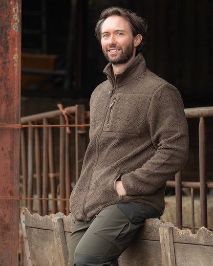Green coloured Jack Pyke Shires Fleece Jacket on yard background #colour_green