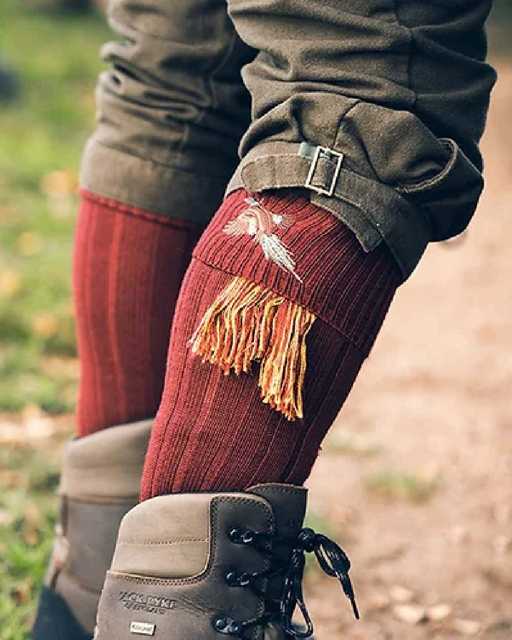 Burgundy coloured Jack Pyke Shooting Socks Pheasant on blurry background #colour_burgundy
