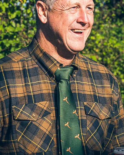 Green coloured Jack Pyke Shooting Tie Pheasant on blurry background #colour_green