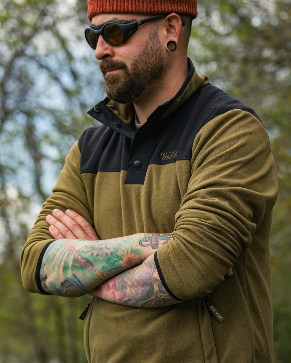 Dark Mustard coloured Jack Pyke Snap Neck Fleece Top on forest Background #colour_dark-mustard