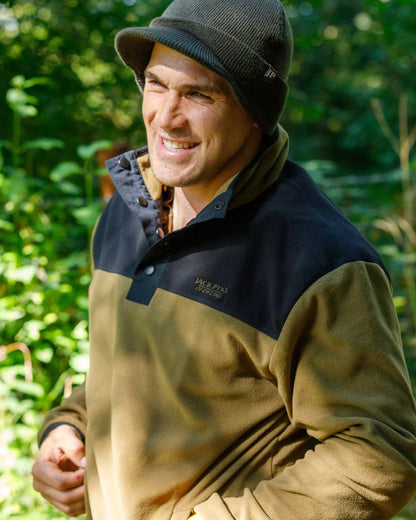Dark Mustard coloured Jack Pyke Snap Neck Fleece Top on forest Background #colour_dark-mustard