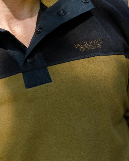 Dark Mustard coloured Jack Pyke Snap Neck Fleece Top on forest Background #colour_dark-mustard