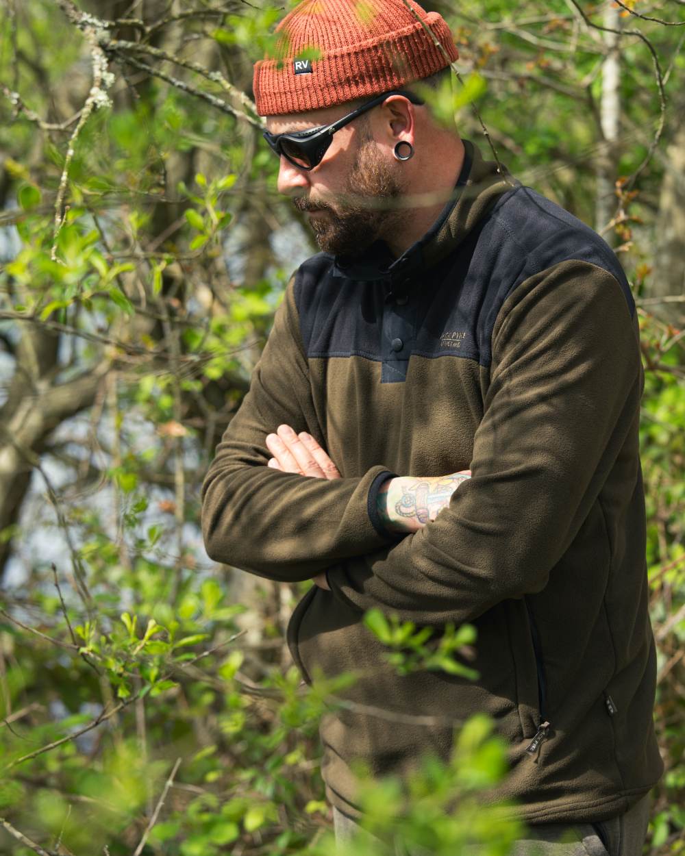 Dark Olive coloured Jack Pyke Snap Neck Fleece Top on forest Background #colour_dark-olive