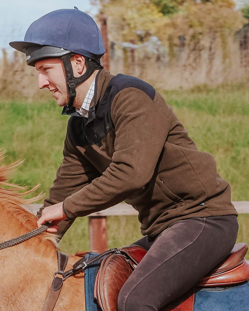 Dark Olive coloured Jack Pyke Snap Neck Fleece Top on grassy Background #colour_dark-olive