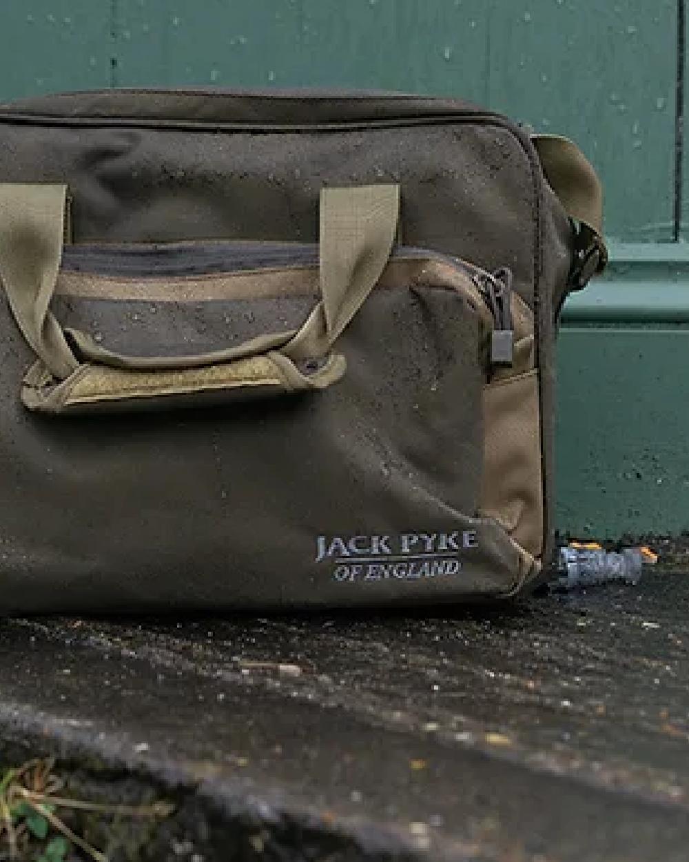 Brown coloured Jack Pyke Sporting Shoulder Bag on door background #colour_brown