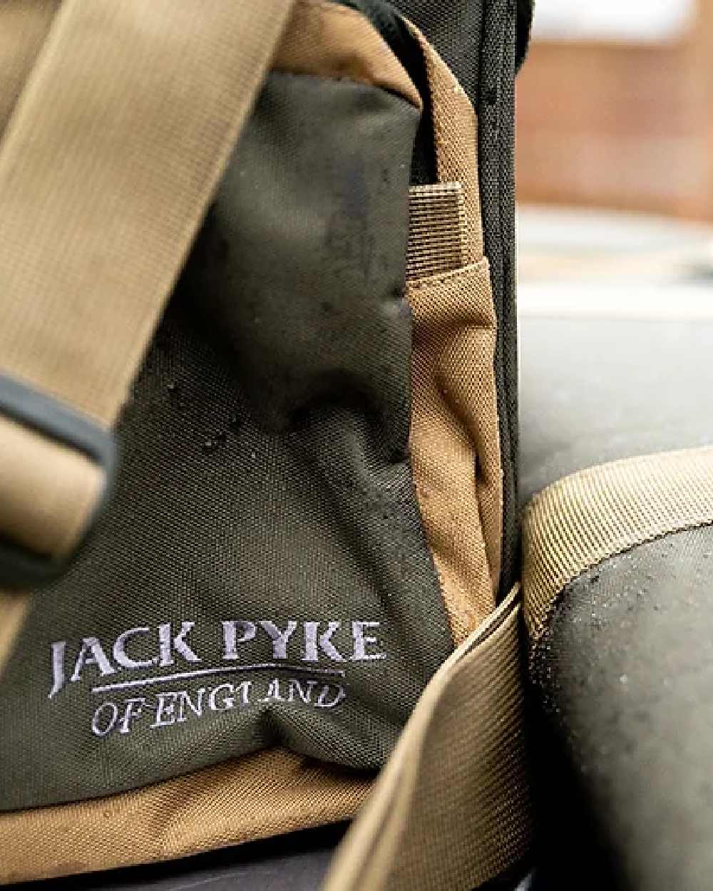 Brown coloured Jack Pyke Sporting Shoulder Bag on blurry background #colour_brown