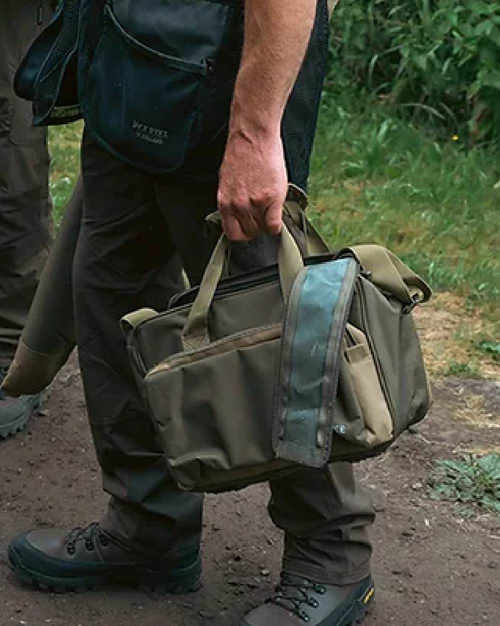 Green coloured Jack Pyke Sporting Shoulder Bag on mud background #colour_green