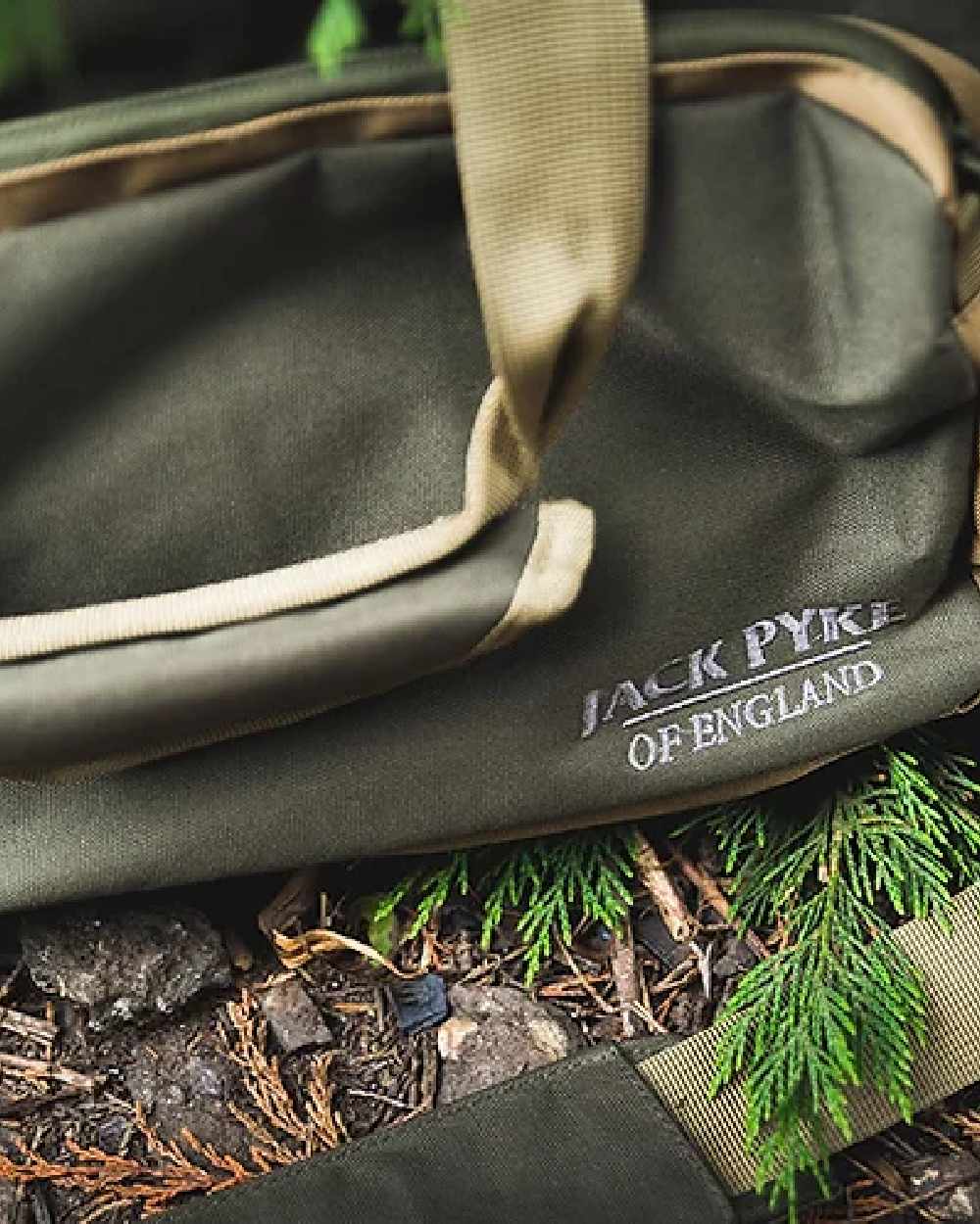 Green coloured Jack Pyke Sporting Shoulder Bag on mud background #colour_green