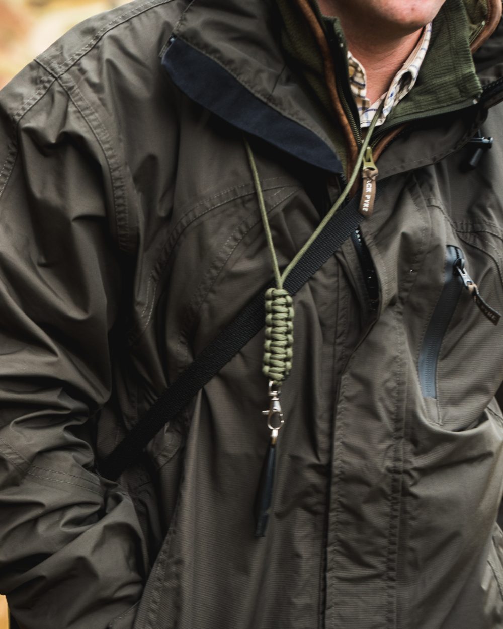 Hunter Green coloured Jack Pyke Technical Featherlite Jacket on mountain background #colour_hunter-green