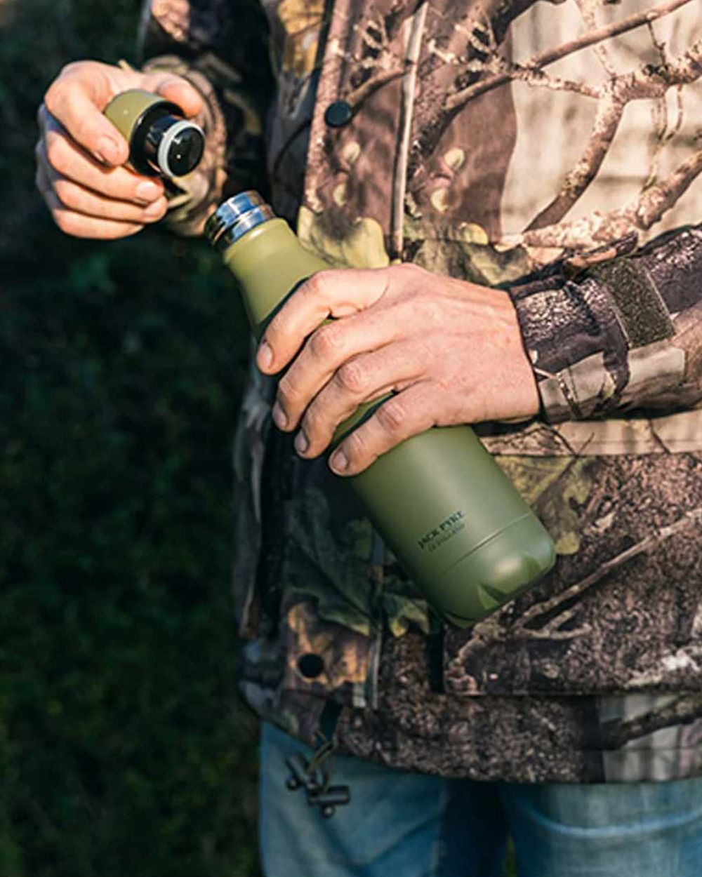 Matt Green coloured Jack Pyke Thermal Bottle on blurry background #colour_matt-green