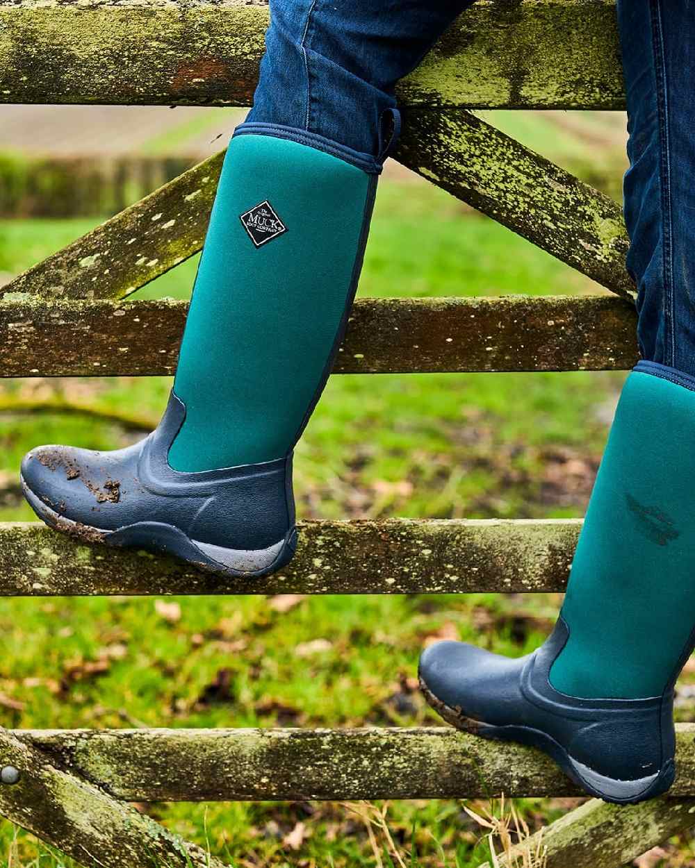 Navy Spruce Coloured Muck Boots Womens Arctic Adventure Tall Boots on blurry background #colour_navy-spruce