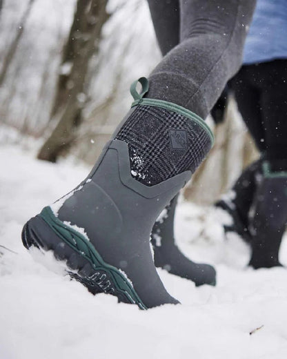 Grey Plaid Print Coloured Muck Boots Womens Arctic Sport II Mid Wellingtons on snow background #colour_grey-plaid-print